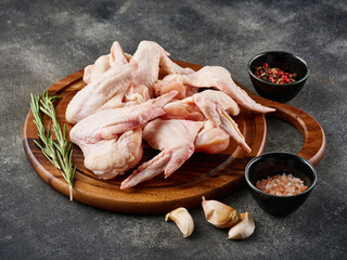 Uncooked chicken wings with spices. Raw meat. Raw Chicken wings.