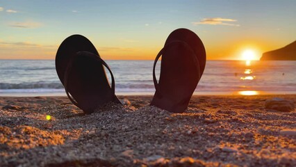 flip flop on beach at sunset