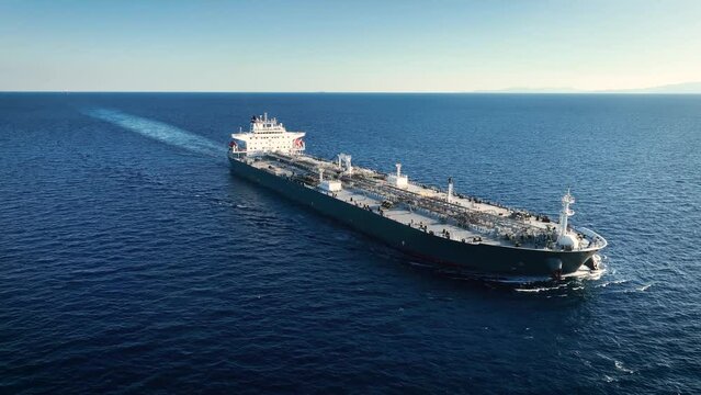 Aerial view of a large, heavy loaded crude oil tanker traveling over open ocean