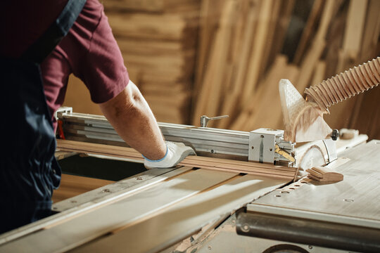 carpenter in a carpentry workshop makes products, furniture production concept