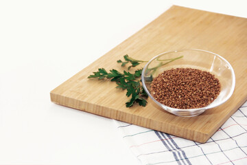brown small grains of buckwheat in a decorative glass plate