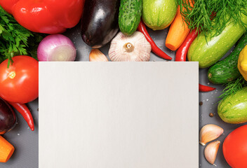 Empty sheet of paper on the background of vegetables. Recipe for a healthy diet.