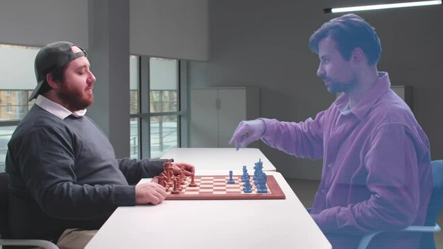 Overweight man play virtual chess with opponent hologram