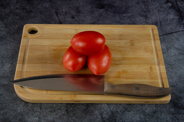 Red ripe tomatoes on a cutting board