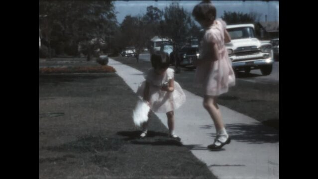 Helping Sister 1966 - A girl falls in her yard and her sister comes to her aid in Canoga Park, California 1966. 
