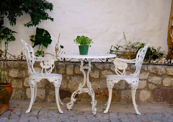 white table and chairs in a garden