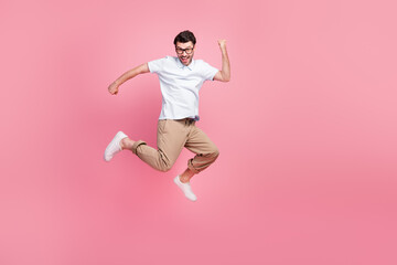 Fototapeta na wymiar Full length photo of glad satisfied man rejoice career promotion boss chief position empty space isolated on pink color background