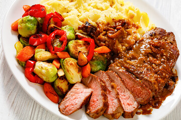 beef steak with potato mash and roasted vegetables