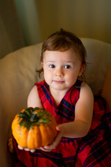 Fototapeta premium happy baby with a pumpkin for Halloween home