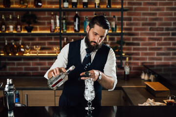 barman prepares cocktail in club