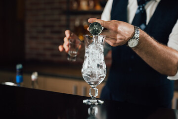 barman prepares cocktail in club