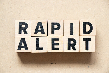 Alphabet letter block in word rapid alert on wood background
