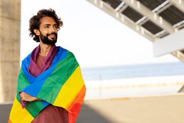 Happy man with a pride flag. LGBT community.