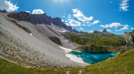 Panoramic mountain chain along the Tirol Sexten alps and lake with crystal clear drink water
