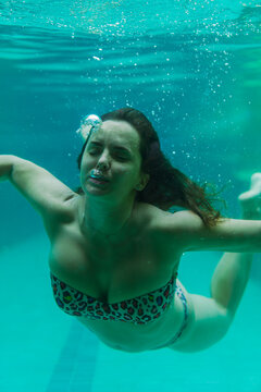 Young woman in the pool underwater, underwater shooting