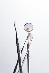 Dental instruments used by a dentist in daily practice on a white background