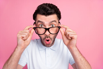 Closeup photo of young handsome shocked funny excited guy wear glasses pouted lips hold spectacles reaction look you isolated on pink color background