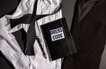 DRESS CODE text on notepad with black and white clothes