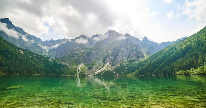 Green water and cloudy lake Morskie Oko, Tatra Mountains, Poland. Timelapse 4K