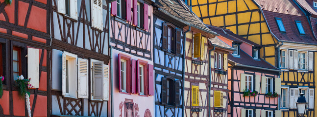 Bright colorful facades with wooden partitions and  windows with shutters of traditional fairy...