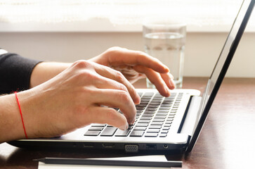 Freelancer's workplace at a table near the window. Home office