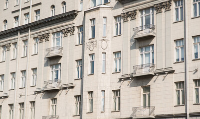 Fototapeta premium View of the facade of the house with windows and a balcony.