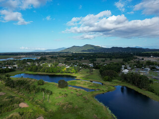 Obraz premium Aerial view of a lake a mountains with blue and cloudy sky