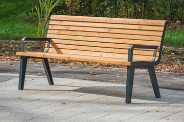 Wooden bench in the autumn city park.