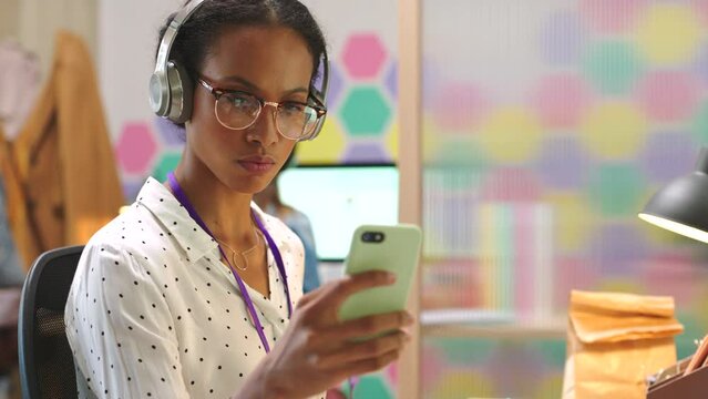 Woman, computer or headphones for phone music playlist, podcast or radio motivation audio. Digital marketing worker, advertising employee or creative office business people on social media technology
