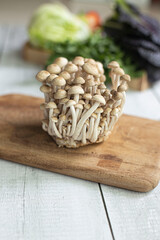 Fototapeta na wymiar Fresh white mushrooms on cutting board.