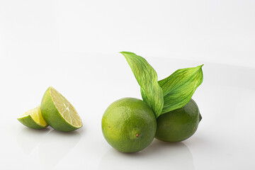Green lime with cut in half and slices isolated