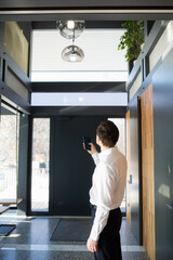 Man controlling home light with digital tablet in his house. Concept of smart home and light control with phone, mobile devices.