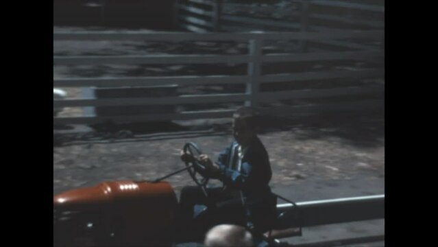 Driving a Tractor 1968 - A boy drives a miniature tractor at a petting zoo in 1968.