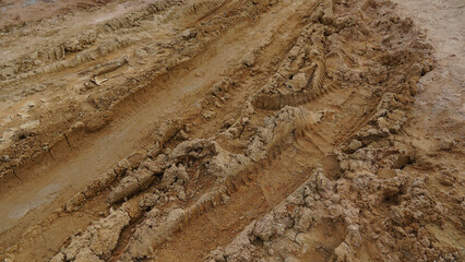 Wheel drift on dry muddy roads. Dirt road surface for transport background.