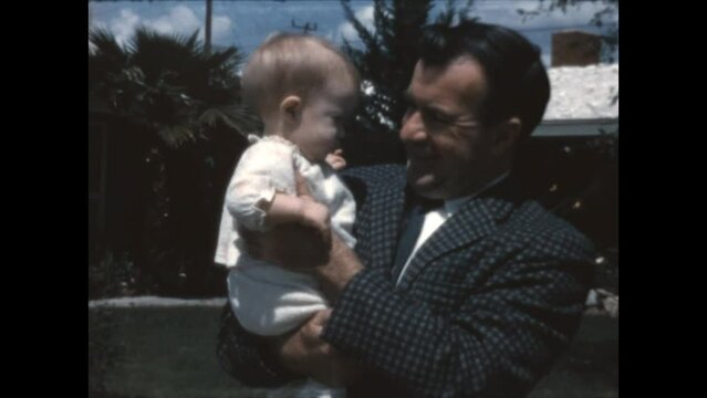 Father and Son 1965 - A father holds his young son in Canoga Park, California in 1965.