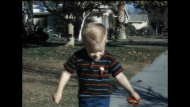 Playing on the Sidewalk 1967 - A boy plays with his wagon and toy truck on the sidewalk in front of his home in Canoga Park, California in 1967. 