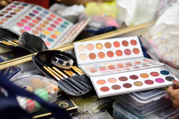 Makeup kits laying down on table haphazardly