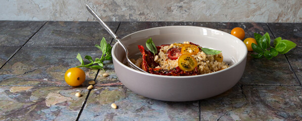 bowl with salad with quinoa, fresh and sundried tomatoes on the table - obrazy, fototapety, plakaty