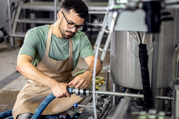 Male brewer working in a craft brewery.