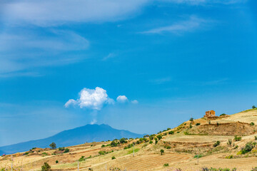 Fototapeta premium An eruption of the Etna volcano on the island Sicily in Italy on a beautiful summer day and a beautiful landscape.