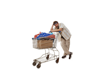 Portrait of man with big shopping trolley with household good feeling tired isolated over white...