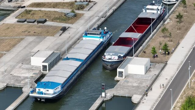 Freight ships sailing on the Albert Canal towards Liege close to the river Meuse and the Lanaye locks. Drone point of view.