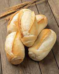 French bread, salt bread or pistolet over wooden table