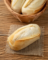 French bread, salt bread or pistolet over wooden table