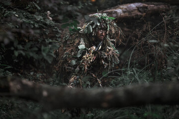 Eastern special forces soldier with rifle in woodland
