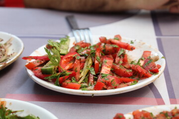 some salad and onions diced on white plates
