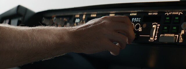 CU Commercial aircraft pilots adjusting radio channel parameters during the flight at high...