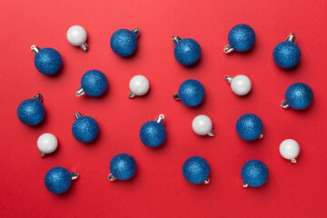 Christmas balls on color background, top view