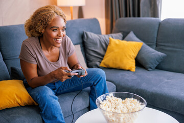 Woman having fun playing video games at home © Impact Photography