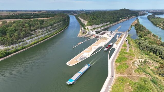 Freight ships sailing on the Albert Canal towards Liege close to the river Meuse and the Lanaye locks. Drone point of view.
